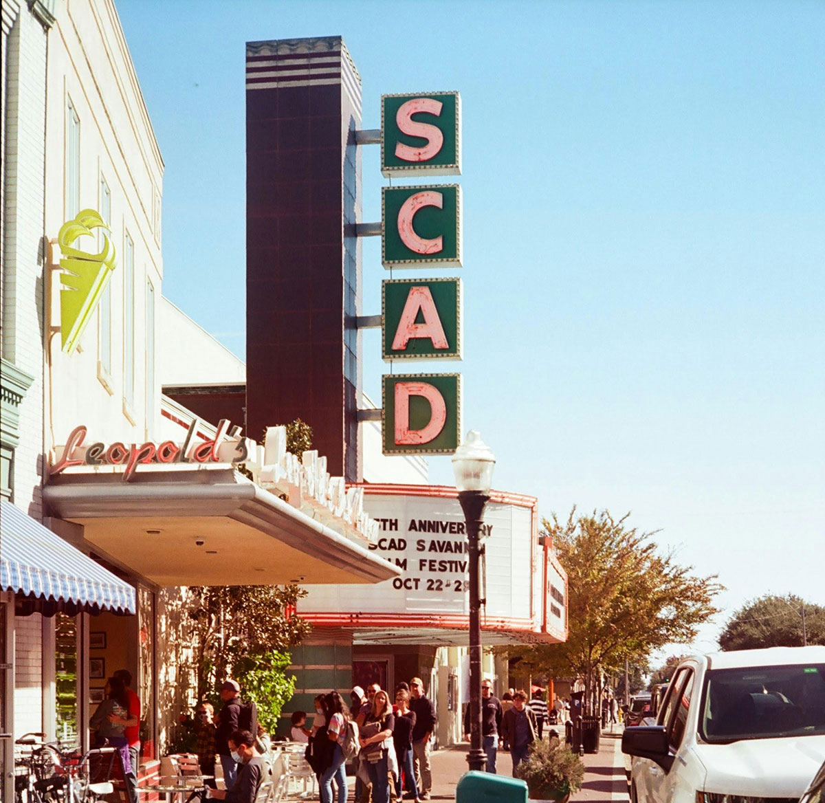 People walking on sidewalk in front of SCAD